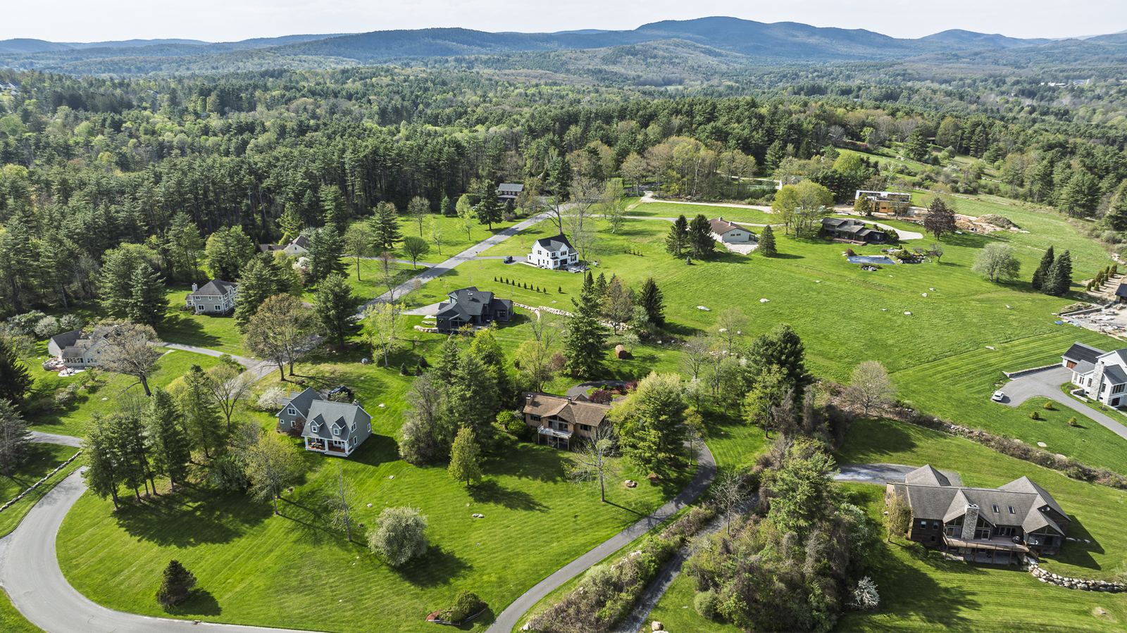 Aerial view of countryside homes with mountains beyond