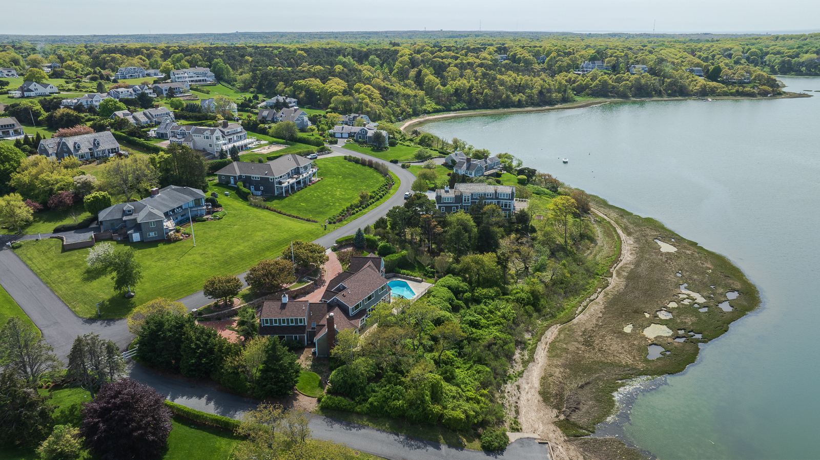 Aerial view of shoreline homes along a cove
