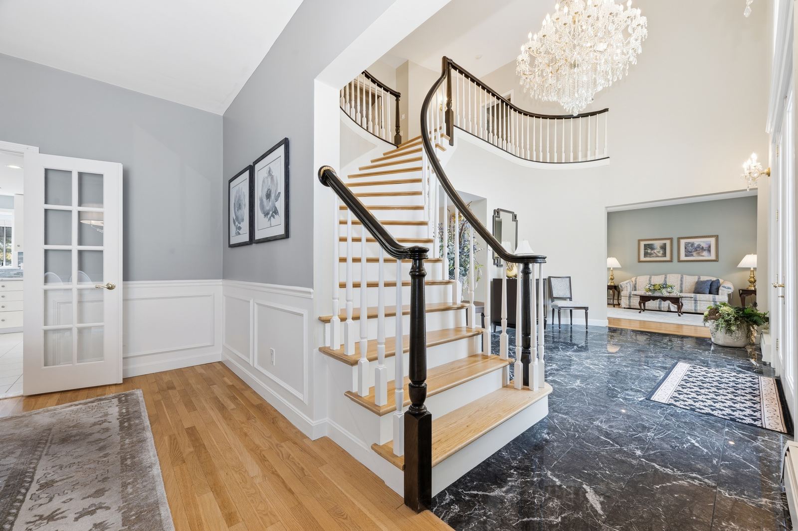 Foyer with curved staircase and chandelier