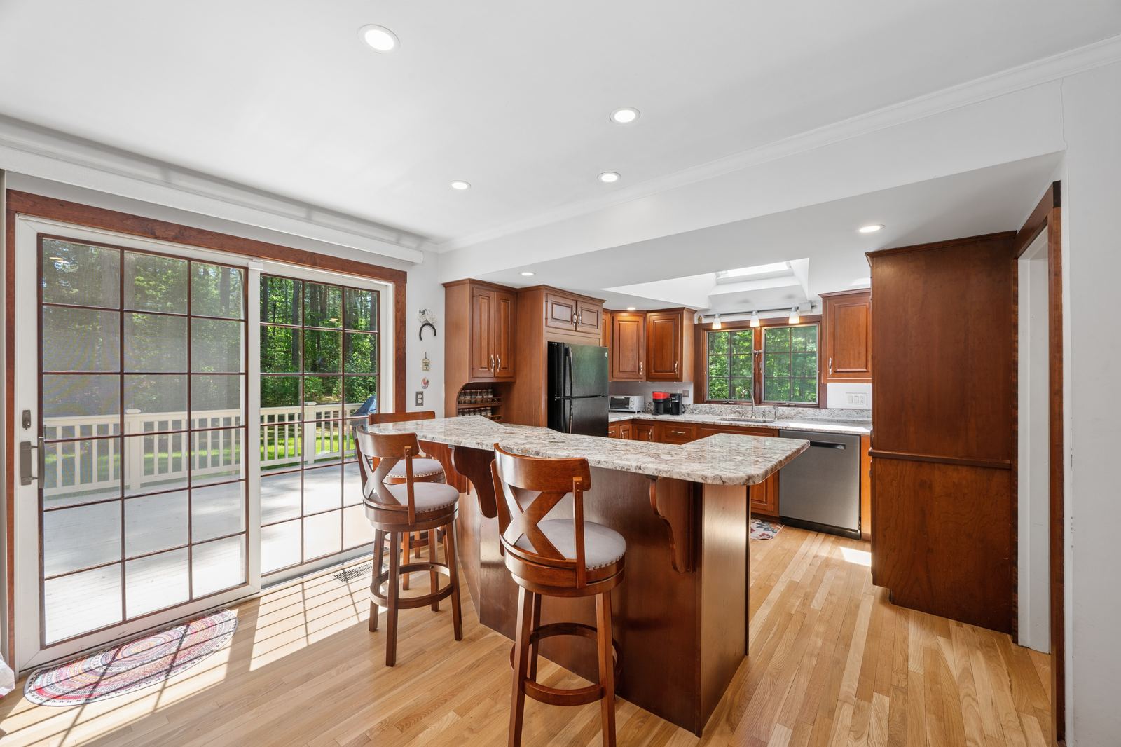 Kitchen opening to a deck